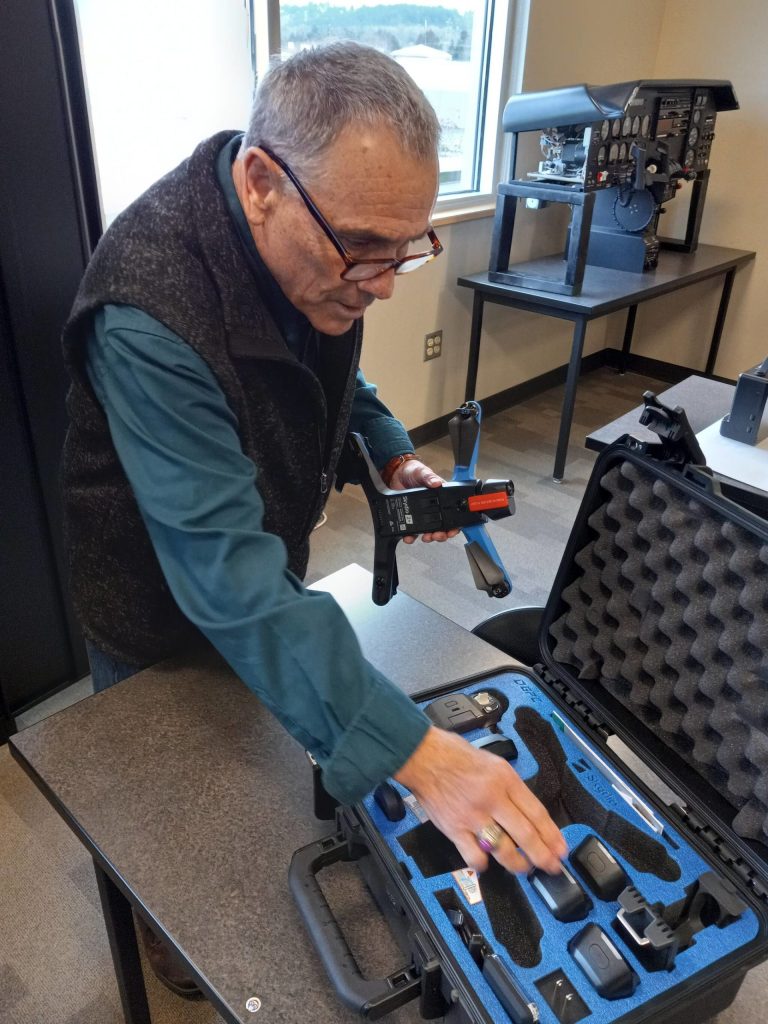 Instructor Frank Cantwell prepares to assemble a drone at the GRC Aviation Center.