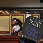 Betty Taylor shows a plaque for Chief Andy Hwang and the Federal Way Police Department, thanking them for how they handled a recent situation. Alex Bruell / The Mirror