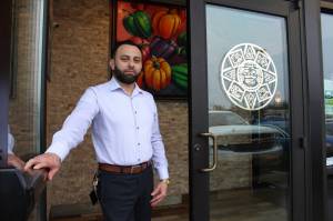 Jaime Monje holds open the door at the Azteca Mexican Restaurant in Federal Way, where he is the general manager. Alex Bruell / The Mirror