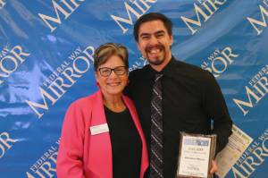 Federal Way Mirror Multi-Media Sales Manager Cindy Ducich stands with the Best Fitness Facility winner, BestHour Fitness. Alex Bruell / The Mirror
