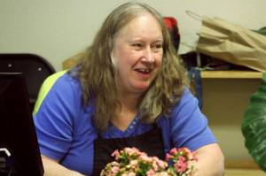 Alex Bruell / The Mirror 
Tammy Solomon laughs while talking with clients and staff at the Multi-Service Center foodbank the morning of Friday, March 24.