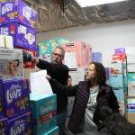 Volunteers move boxes of diapers at Do The Right Things annual diaper drive Wednesday morning.