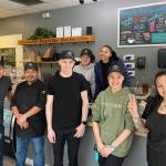 The Poverty Bay Cafe staff takes a moment to pose for a photo during a busy morning at the cafe on April 26. Olivia Sullivan / Federal Way Mirror