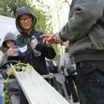 Green Gables student Lang prepares to pour a tiny salmon fry into Brook Lake during an April 27 field trip at the West Hylebos Wetland. Alex Bruell / The Mirror