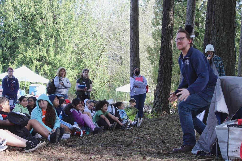 David Turnipseed, of the Puyallup Tribe, roars as the black bear in the story of Black Bear and Ant. Enterprise Elementary School students called out Habu, a Lutshootseed word, to tell the performers Im listening during an April 27 field trip at the West Hylebos Wetland. Alex Bruell / The Mirror