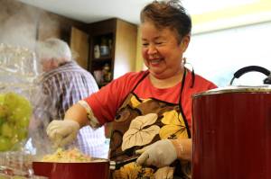 Mercedes Porras prepares a rice and veggies dish and shows off more homemade treats in these photos taken May 6 at the Church of the Good Shepherd. We love Mercedes, the volunteers agreed. Alex Bruell / The Mirror