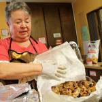 Mercedes Porras prepares a rice and veggies dish on May 6 at the Church of the Good Shepherd. We love Mercedes, the volunteers agreed. Alex Bruell / The Mirror