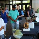 Visitors peruse the displays at the Arts Explosion event Friday afternoon, while a harpist performs in the background. Alex Bruell / The Mirror