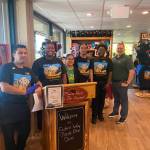 Staff members and Regional Director Of Operations Chris Spenhoff, far right, greet customers on June 3. Olivia Sullivan / the Mirror