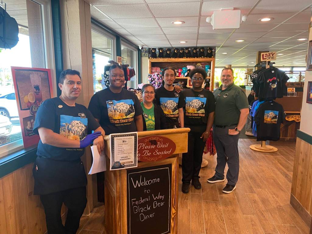 Staff members and Regional Director Of Operations Chris Spenhoff, far right, greet customers on June 3. Olivia Sullivan / the Mirror
