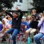 Alex Bruell / The Mirror 
Kids celebrate during the ladder-truck egg drop after one of the eggs, incredibly, rolls to safely after its package collides harshly with the ground.