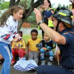 A student at Green Gables elementary celebrates their successful egg drop with SKFR Driver-Engineer Adam Joyner. Alex Bruell / The Mirror
