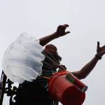 Firefighter Tyler Morris drops an egg payload to the ground from atop a South King Fire & Rescue ladder. Alex Bruell / The Mirror