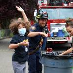 A student at Green Gables elementary celebrates their successful egg drop with SKFR Driver-Engineer Adam Joyner. Alex Bruell / The Mirror
