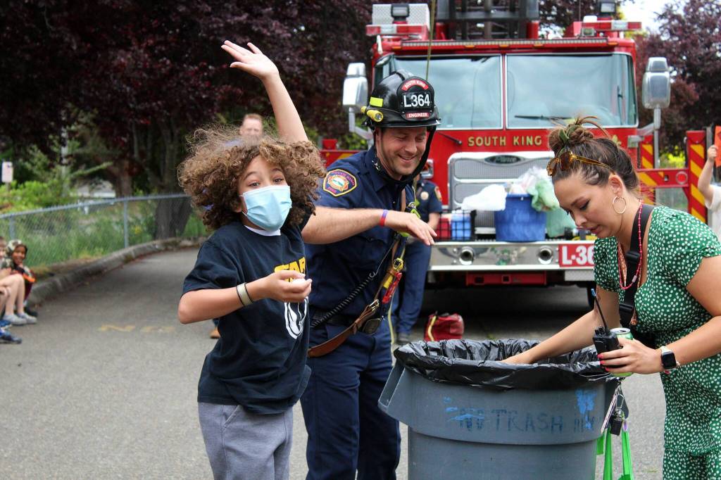 A student at Green Gables elementary celebrates their successful egg drop with SKFR Driver-Engineer Adam Joyner. Alex Bruell / The Mirror