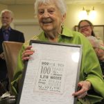 Village Greens Esther Vine holds a sign at her 100th birthday marking the time shes spent alivewhich comes out to more than 36,000 days, or 52 million minutes. Alex Bruell / The Mirror