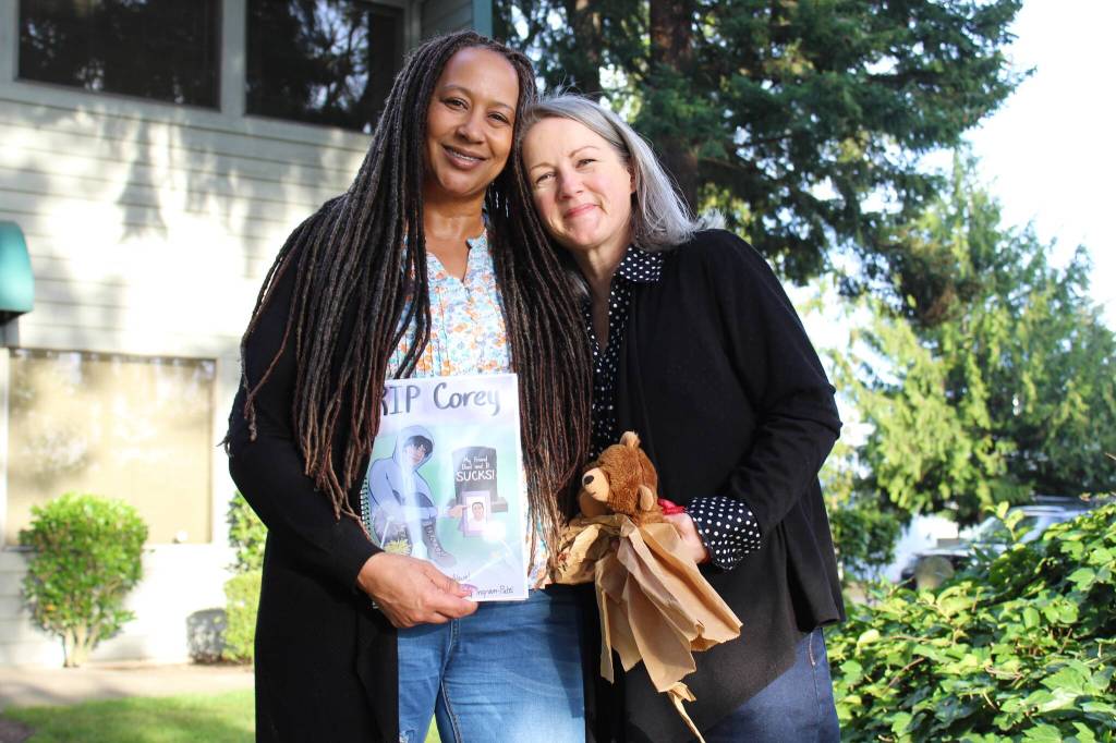 Deena Rose, left, and Chris Buchanan stand outside Buchanans office in Federal Way. Buchanan has written a book for youth exploring their grief. Alex Bruell / The Mirror