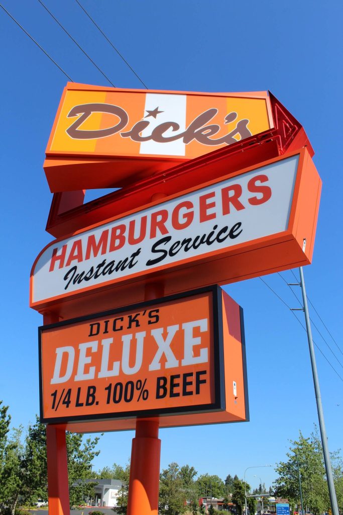 The top sign at the new Federal Way Dicks Drive-In spins, greeting drivers on Pacific Highway. (Alex Bruell / The Mirror)