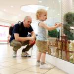 Jared Gloster and son Gavin enjoy a display of life size toy dogs at the Commons Mall in Federal Way. Photo by Keelin Everly-Lang / The Mirror