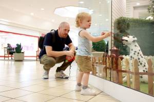 Jared Gloster and son Gavin enjoy a display of life size toy dogs at the Commons Mall in Federal Way. Photo by Keelin Everly-Lang / The Mirror