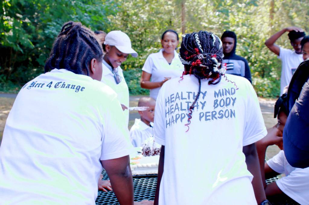 AYDEPI youth gather to celebrate one members birthday with cake at the volunteer event. Photo by Keelin Everly-Lang / The Mirror