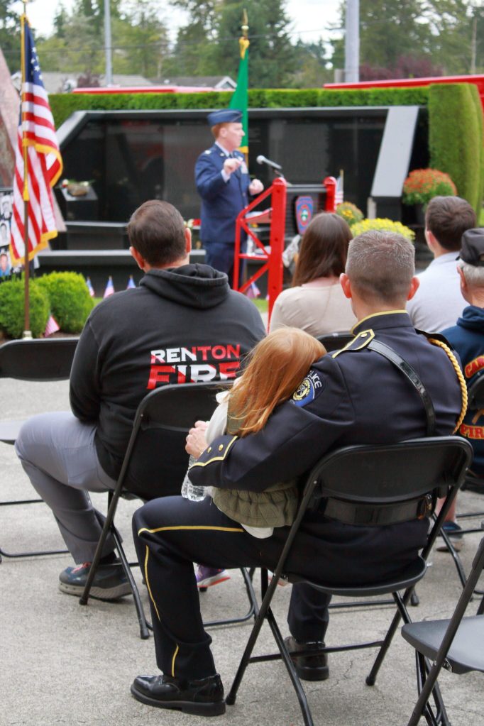 Lieutenant Jeff Mundell and his daughter watch Colonel Michael F. Keenan speak at the memorial event. Photo by Keelin Everly-Lang / The Mirror