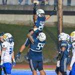 Jireh Ioane lifts up Nehemiah Washington after a touchdown. Photo by Dee Torres