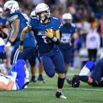 QB Spencer Holloway on the move in the win over Tahoma. Photo by Dee Torres