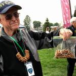 Federal Way Symphony volunteer Bob Kellogg sells pretzel necklaces at the Blues Festival held in 2017 at Town Square Park. (Mirror file photo)