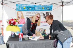 Local Realtor Pauline Jones gets her copy of Vickie Chynoweths new cookbook signed at the Federal Way Farmers Market on Saturday. Photo by Keelin Everly-Lang / The Mirror