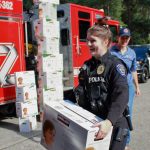 Photo by Keelin Everly-Lang / The Mirror
Federal Way Police Department Officer Britney Paul carries a case of diapers that are ready for donation.