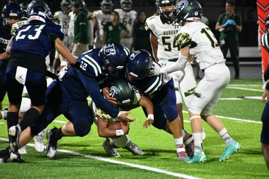 A duo of Titans combine to take down the Trojan ball carrier. Ben Ray / The Mirror