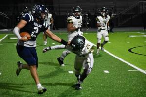 Senior Dominic Simpson stiff arms a defender. Ben Ray / The Mirror