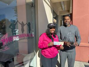 Executive Director Carlecia Bell of Phenomenal She poses with Winston Bell of Game of Life Mentoring with their Community Partnership Award from South King Fire in front of Phenomenal Shes location in Federal Way. Both organizations focus on helping local people of color. Learn more at phenomenalshe.org and gameoflifementoring.org. (Photo provided by Phenomenal She)