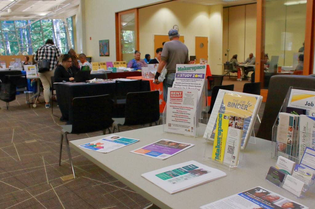 Libraries often have permanent tables of resources even when a fair isnt in session, like these materials at a table in front of the resource fair. The fair is held in the main area of the library near banks of computers making it accessible and easy to find. (Photo by Keelin Everly-Lang / The Mirror)