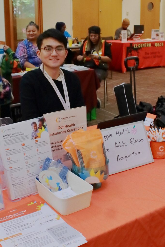 Patrick Fu is an Account Manager for Community Health Plan of Washington. He had a variety of free resources and was available to help people sign up for health insurance right then and there. (Photo by Keelin Everly-Lang / The Mirror)