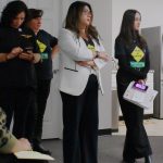 Jacqueline Garcia Castillo stands with members of her team and a leader at Casa Latina as she watches the City Council Candidates respond to voters on Wednesday. Photo by Keelin Everly-Lang / The Mirror.