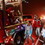 Santa and Mrs. Claus hand out candy canes during their parade route.