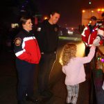 Captain Browning of South King Fire and her family enjoy the festivities while bringing joy to other families during the Santa Parade on Dec. 12. Photo by Keelin Everly-Lang / The Mirror