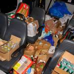 Food donations are piled high in the Parks donation collection bus after the Dec. 12 Santa Parade. Photo by Keelin Everly-Lang / The Mirror