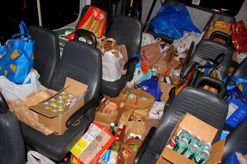 Food donations are piled high in the Parks donation collection bus after the Dec. 12 Santa Parade. Photo by Keelin Everly-Lang / The Mirror