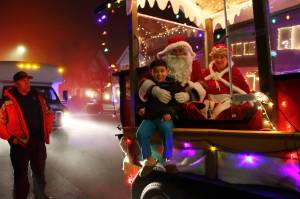 Kids could sit with Santa for photos at the spontaneous stops along the Santa Parade route on Dec. 12. Photos by Keelin Everly-Lang / The Mirror