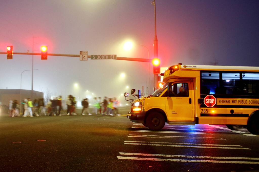 Student protesters cross Pacific Highway South to advocate for increased safety measures in the intersection and other streets surrounding their school. (Photo by Keelin Everly-Lang / FW Mirror)