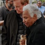 King County Councilmember Pete von Reichbauer stood with Beverly Kelly, a descendant of John N. and Mary L. Conna, as she was overwhelmed by emotion during the unveiling of the Conna Family mural. In 1885, the Connas settled on 157 acres near Panther lake, near what is now the Weyerhaeuser Aquatic Center in Federal Way. They later donated that land to the city. On Oct. 13, a King County Metro bus stop mural celebrating their life and contributions was unveiled in a ceremony. (Photo by Keelin Everly-Lang / The Mirror)