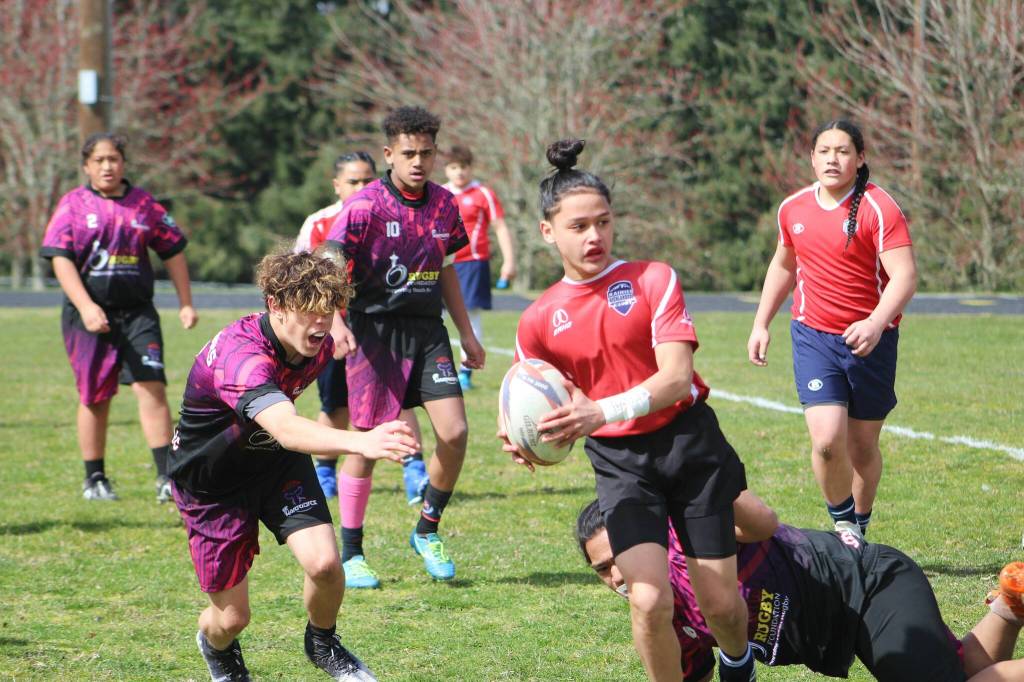 The Federal Way Warriors under-14 team (purple) played a hard-fought game March 25, but ultimately fell to the Rainier Highlanders. They youth rugby team is in its second year, and founders say the game teaches life lessons and helps the kids foster connections. (Photo by Alex Bruell / The Mirror)