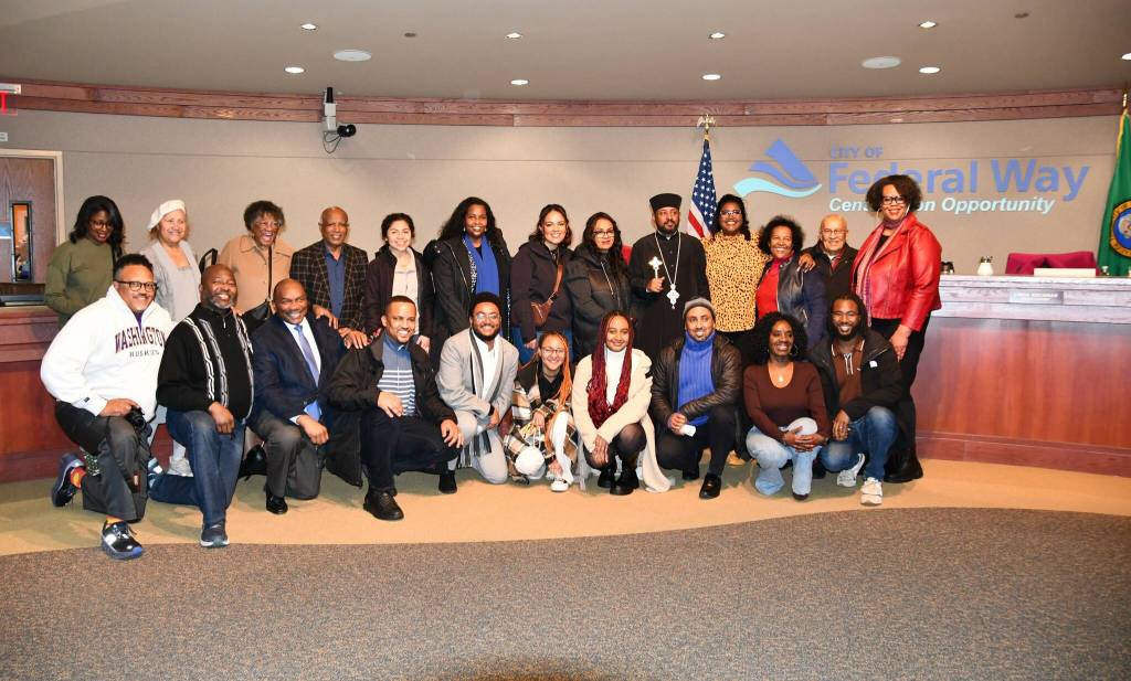 Federal Way City Councilmember Lydia Assefa-Dawson poses with family, friends and community members who came to cheer her on as she was sworn in. Photo by Bruce Honda