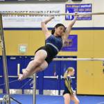 Allison Truong from Decatur dismounts off of the bars. Ben Ray / The Mirror