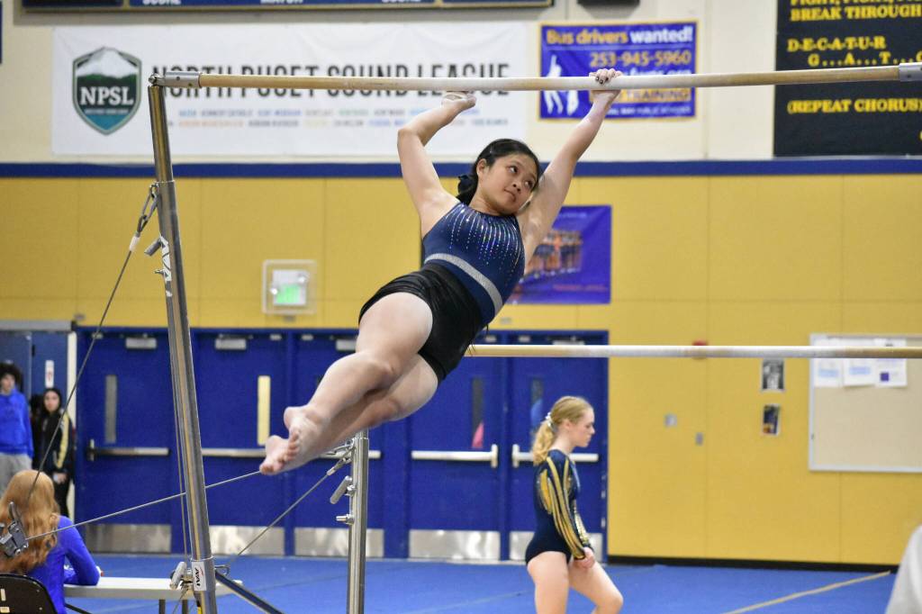 Allison Truong from Decatur dismounts off of the bars. Ben Ray / The Mirror