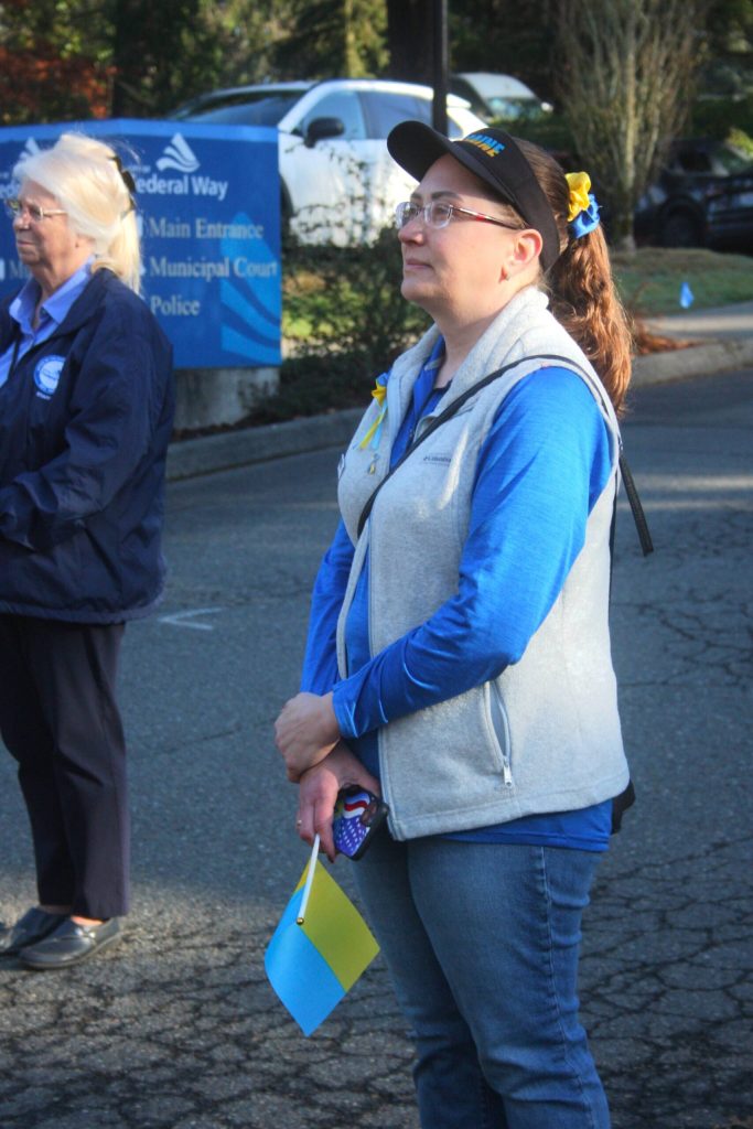 Elena Moscova listens to speakers at the raising of the Ukrainian flag at Federal Way City Hall on Friday, Feb. 23. (Photo by Keelin Everly-Lang / The Mirror)