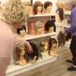 Photo by Bailey Jo Josie/Sound Publishing
Staffers at Master Hair Care try and find the best wig.